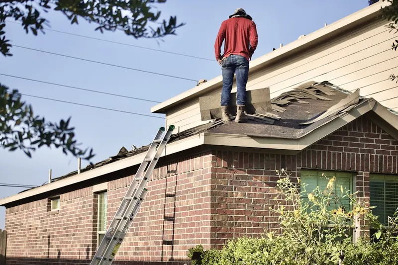 Professional roofer working on a residential roof in Verdemont